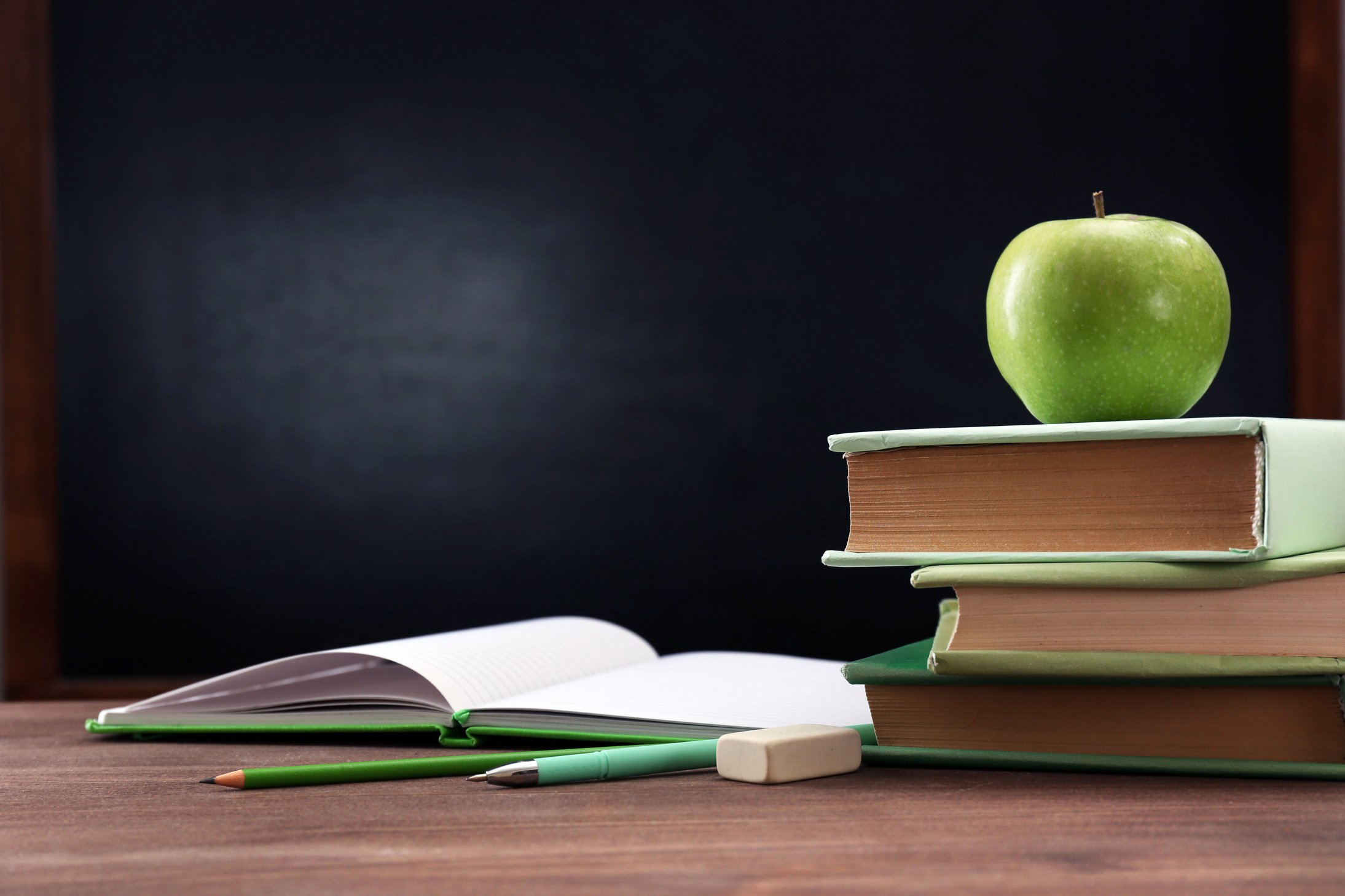 Apple and Books on Desk Background